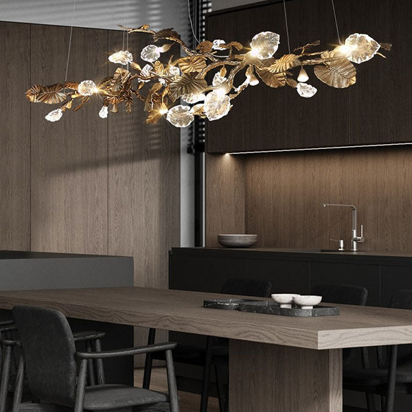 Elegant Lotus chandelier featuring delicate lotus leaf pendants made of transparent material, capturing light with a crystalline shimmer. The slender, organic brass copper branch adds warmth, while the LED lights provide a cool glow. Ideal centerpiece for a sophisticated dining area or tranquil bedroom retreat.