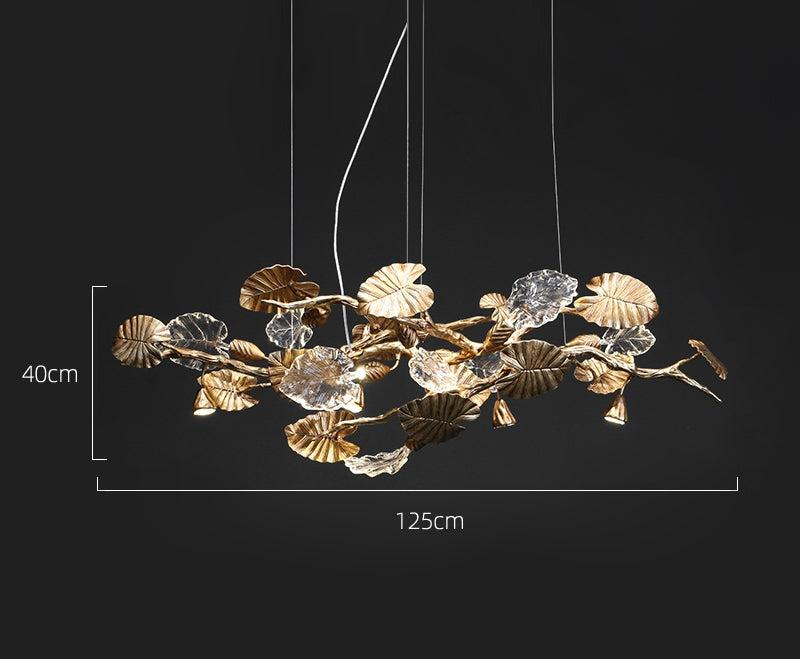 Elegant Lotus chandelier featuring delicate lotus leaf pendants made of transparent material, capturing light with a crystalline shimmer. The slender, organic brass copper branch adds warmth, while the LED lights provide a cool glow. Ideal centerpiece for a sophisticated dining area or tranquil bedroom retreat.