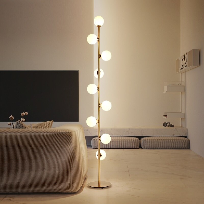 Lights of Scandinavia - Nucleic - Modern LED standing lamp with frosted glass ball fixtures. Nickel gold plated steel body. Suitable for bedrooms, halls or next to a lonely wall.  9 light sources with a coverage of approximately 6-12 square meters, using the included LED Bulbs. Base diameter: 25cm Glass ball diameter: 10cm Specifications Light Source 9x LED Bulbs Base Type G4 Power Consumption 16-20W Is Bulbs Included Yes Dimmable