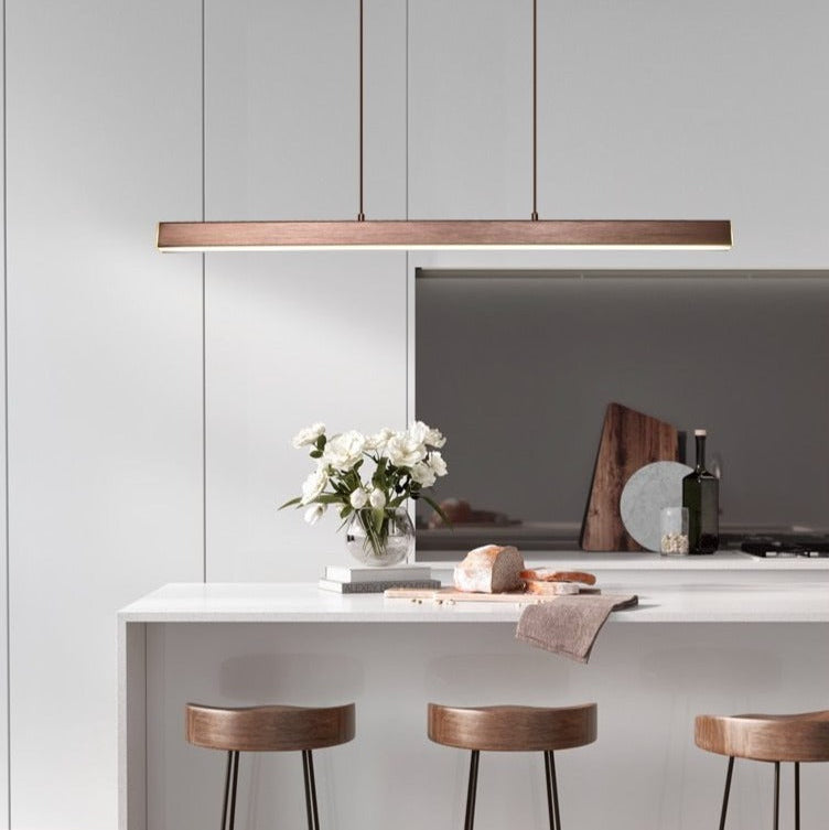 Contemporary dining room featuring a long LED pendant light with a sleek rectangular design.